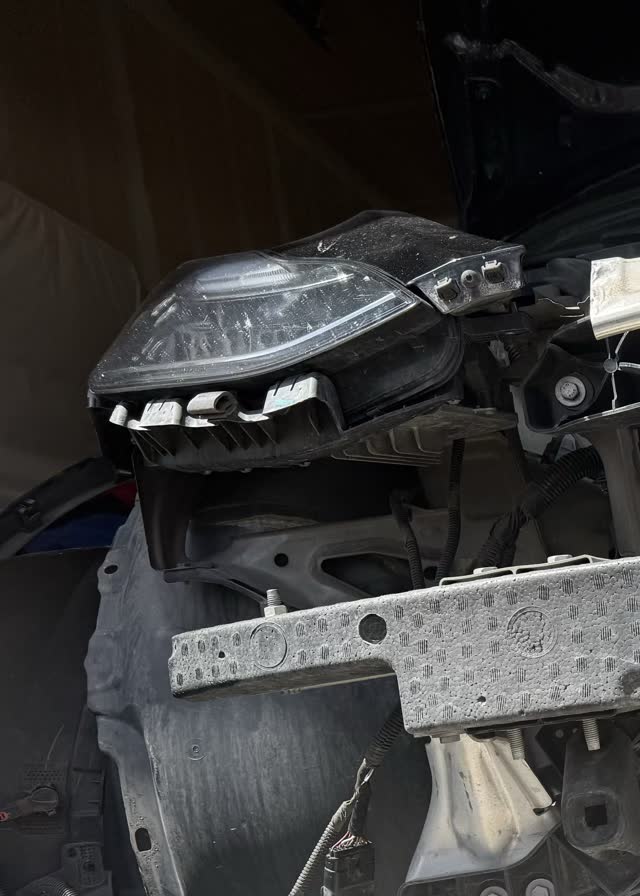 Tesla Model 3 with front bumper removed for professional radiator cleaning service in Utah